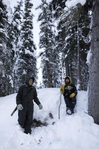 Beattus Moses Jr. and Tig Strassburg look for bear dens during the winter season. (National Geographic/Pat Henderson)