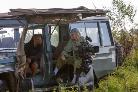 Faith Musembi and Sophie Darlington sit inside the film vehicle with their camera ready and prepared to capture the action. (National Geographic/Jane Atkins)