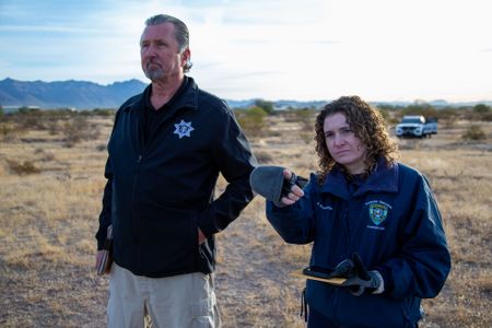 Bruce Anderson, Pima County Medical Examiner's Office, and Stephanie Bourgeois, Crime Scene Technician, Apache Junction PD, pinpoint the spot where the body of Jane Doe was discovered in 1992. (National Geographic/Tom Beard)