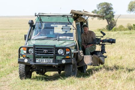 Cinematographer Rolf Steinmann sits in the vehicle with his camera ready and prepared to capture the action. (National Geographic/Faith Musembi)