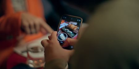 A customer photographs their meal at Ikigai. (National Geographic)