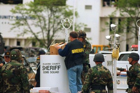 A Team from the Oklahoma Sheriff's Office removes a device, incorrectly assumed to be a second bomb, from the scene of the Alfred P. Murrah Federal Building in Oklahoma City, Okla. (Danny Atchley)