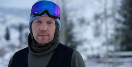 Travis Rice, Big Mountain Snowboarder, stands in the snow wearing his snowboarding gear. (National Geographic/Ross McDonnell)