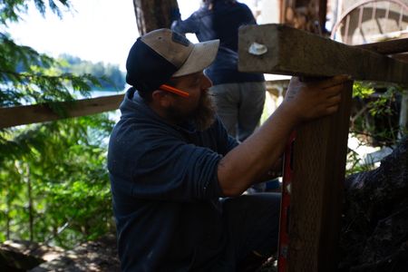Carl Hernandez helps construct a ramp on his neighbor's property. (National Geographic/Mickey Ramos)