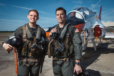 Students LTJG Evan Morris and 1st LT Andrew Walsh pose in front of a T-45. (Credit: National Geographic/Freddie Claire)