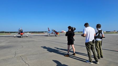 Camera Jack Brophy, Director Joe Keenan, and sound recordist Phil Bax filming students getting into their jets at Key Field Airport. (Credit: National Geographic/Lyndsi Gutierrez)