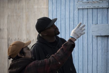 Marvin Agnot and Glyndaril White, Jr. rebuild the side of Marvin's home that was damaged due to old age and rot. (National Geographic/Lauren Bird Dixon)