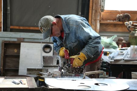 Sam Carlson constructs a new fairlead for his friend's skiff. (National Geographic/Wayne Moss)