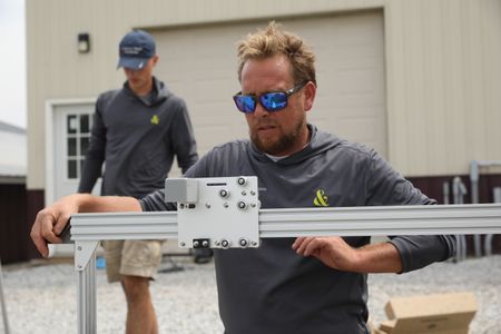 Sam Korthals and Ben Reinhold set up Robot Garden system at the Pol family farm's garden. (National Geographic)