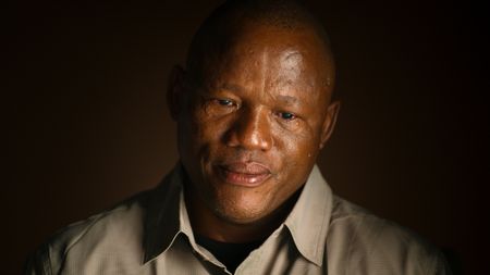 San Guide, Kane Motswana, tears up during an interview. (credit: National Geographic)