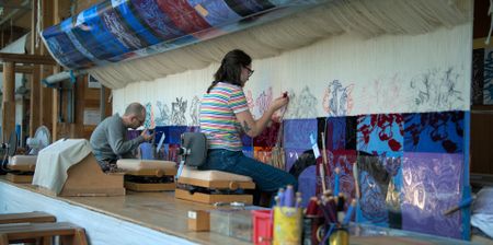 Craftspeople Christopher and Suzon hand weave a carpet at Mobilier National. (National Geographic)
