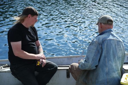 David Squibb and Sam Carlson take measurement's of Squibb's skiff, ahead of constructing a new fairlead for the boat. (National Geographic/Wayne Moss)
