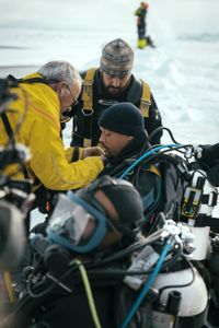 Will Smith prepares to dive under the ice with Dr. Allison Fong to collect samples in the waters of the North Pole. (credit: National Geographic/Freddie Claire)