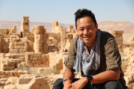 Petra, Jordan - Albert Lin with Khirbet edh Dharih in the background. (National Geographic)