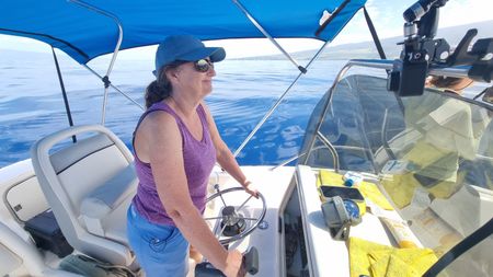 Humpback whale researcher Dr. Rachel Cartwright drives a boat near Maui, HI. (National Geographic for Disney/Rory Dormer)