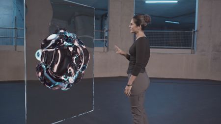 Dr. Diva Amon next to the GFX 'Coral' special information board whilst in the shark lab studio. (National Geographic)