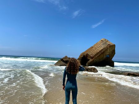 Big wave surfer Justine Dupont, wearing her wetsuit, admires the sea.  (National Geographic/Gene Gallerano)