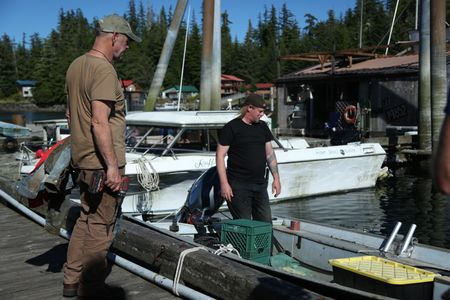 Sam Carlson and David Squibb install a newly constructed fairlead on Squibb's skiff. (National Geographic/Wayne Moss)