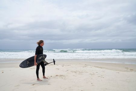 Christian Bungate with his foil board at Cabarita Beach. (National Geographic/Justine Kerrigan)