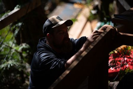 Carl Hernandez helps construct a ramp on his neighbor's property. (National Geographic/Mickey Ramos)