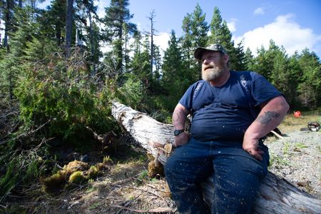 Tim "Curly" Leach helps a neighbor collect lumber. (National Geographic/Kelly Robertson)
