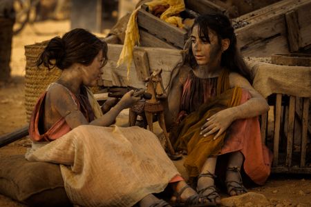 Two young girls, covered in ash, sit in the Pompeii displacement camp and play together with a wooden horse and wooden doll. (National Geographic/Darrin Zammit Lupi)