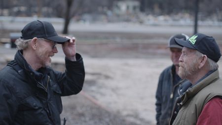 Paradise, CA - Ron Howard (L) tips his hat to Steve "Woody" Culleton (R) on Woody's property in Paradise, CA. (National Geographic/Lincoln Else)