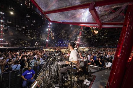 Chris Hemsworth drums during the Ed Sheeran concert in Bucharest. (credit: National Geographic/Evan Paterakis)