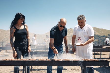 Stanley discovers unexpected delights in this wildest of regions, Abruzzo, one heìs never visited before. He stops at an iconic BBQ joint called Ristoro Mucciante and meets food and motor journalist Cristina Bachetti, left and cooks with one of the owners, Rodolfo Mucciante.  (credit: National Geographic/Matt Holyoak)