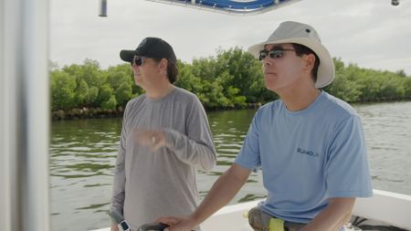 Dr. Neil Hammerschlag and Dr. Stephen Kajiura onboard a boat in Fort Lauderdale, Florida as they discuss the increase of sharks being present in urban areas. (National Geographic)