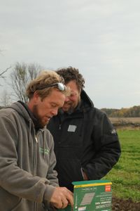 Ben Reinhold and Charles Pol open a box of framing nails at the Pol family's farm. (National Geographic)