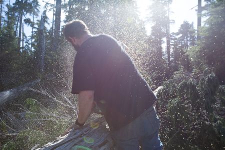 With the help of a neighbor, Oliver Johnson collects lumber. (National Geographic/Kelly Robertson)