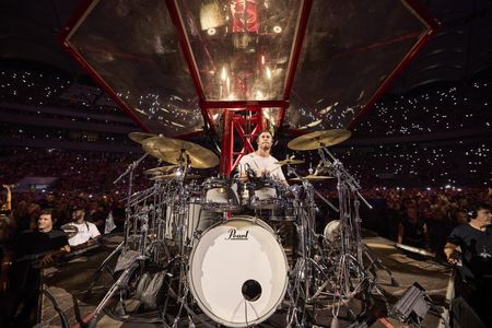 Chris Hemsworth drums during the Ed Sheeran concert in Bucharest. (credit: National Geographic/Evan Paterakis)