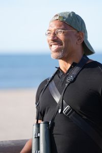 Christian Cooper surveys the beach at Fort Tilden. (National Geographic/Troy Christopher)