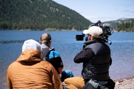 Professional kayaker Ben Stookesberry sits on his kayak and observes the water as DP Ross McDonnell films him from behind, helped by AC Harrison Gayton.  (National Geographic/Harrison Gayton)