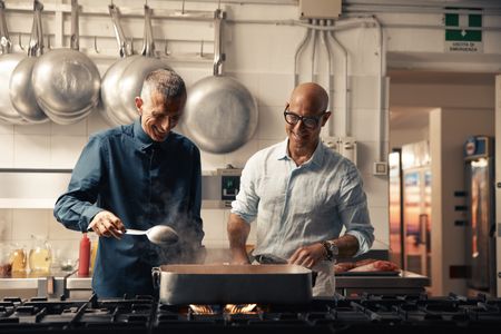 TUCCI IN ITALY - “Sardinia” - Stanley Tucci in the kitchen of Da Tonino with Giuseppe Bertoleoni, the heir to the throne of Tavolara. He also runs the kitchen. (National Geographic/Matt Holyoak)GIUSEPPE BERTOLEONI, STANLEY TUCCI