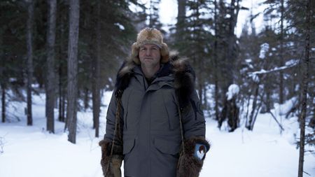 Jamey Joseph setting marten traps in the woods. (National Geographic/Ashton Hurlburt)
