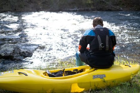 Professional kayaker Ben Stookesberry sits on his kayak and observes the water.  (National Geographic/Harrison Gayton)