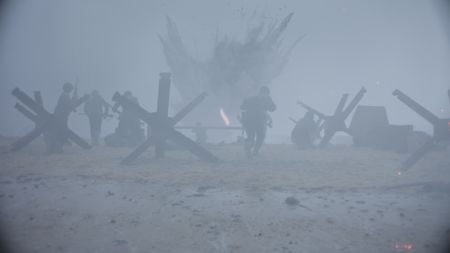 Explosions and chaos surround the soldiers on Omaha Beach in a scene of a WW2 historic reenactment production for "Erased: WW2's Heroes of Color." (National Geographic)