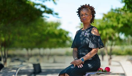 Retired Army Col. Marilyn Wills sits on a bench at the Pentagon 9/11 Memorial with her purple heart award. Wills was working at the Pentagon on 9/11.  (Cheriss May, Ndemay Media Group)