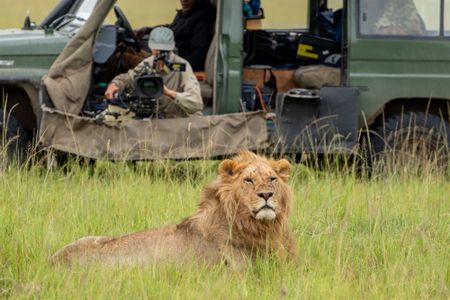 Director of Photography Sophie Darlington looks down the lens as one of Kio’s brothers rests right in front of her in the film vehicle. (National Geographic/Laura McCamley)