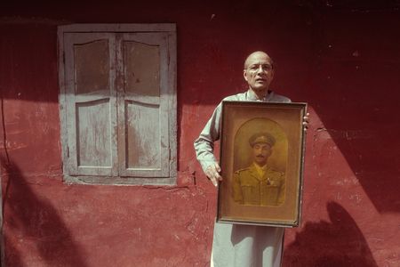 Shahid Khan, Akbar Khan's great grandson holds a portrait of his great grandfather in Karachi, Pakistan. Major Akbar Khan was the most senior Indian in the British Army during WW2 and a member of Force K6, a little known Indian regiment of mule handlers. Amidst the chaos of Dunkirk and the advancing German Army, the Indian regiment fought for victory and independence. (National Geographic/Daniel Dewsbury)