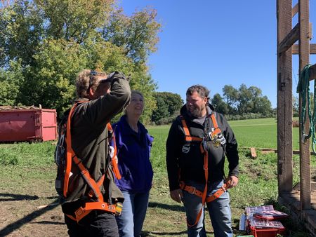 Ben Reinhold, Diane Pol, and Charles Pol talk before Ben and Charles head to the top of the old barn on a lift. (National Geographic)