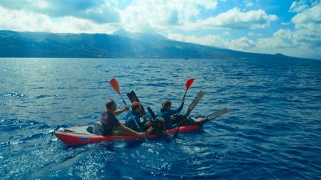 Host, Bertie Gregory, and his team using a kayak for a quiet approach. (credit: National Geographic/Adam Boyle)