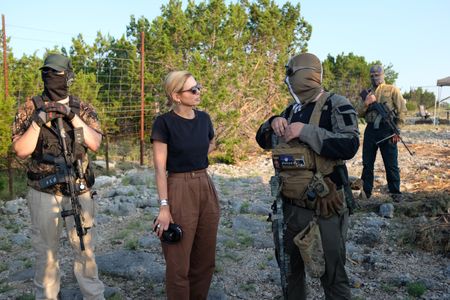 Mariana van Zeller stands with El Gato, co-founder of the Black Cat Rifle Group. (National Geographic)