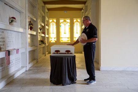 Coroner Scott McCord reflects on the casket containing Adam Doe's remains, which he had interred at his local mausoleum after seven years of trying unsuccessfully to find his family. (National Geographic/Tom Beard)
