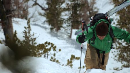Holding poles, Jimmy Chin climbs a mountain covered in snow in the Teton range, Wyoming.  (credit: Teton Gravity Research)