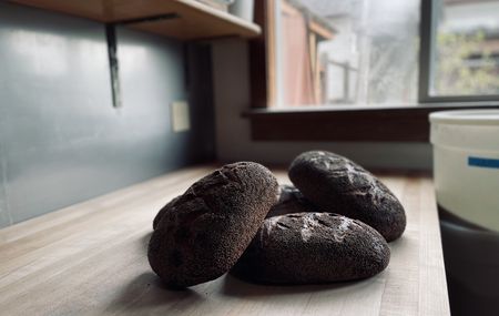 Sesame-encrusted loaves are displayed at Celine Underwood's bakery, Brickmaiden Breads, in Point Reyes, Calif. (National Geographic/Ryan Rothmaier)