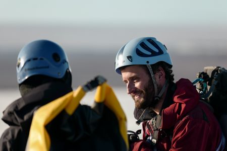 Melissa Marquez talks with Andreas Alexander on a Svalbard glacier hike. (National Geographic/Mario Tadinac)