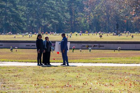Braylon Brown and Marilyn Brown, nephew and sister of Fulton County John Doe David Brown, are guided to David's unmarked grave by Funeral Home Manager Randolph Taylor. (National Geographic/Tom Beard)